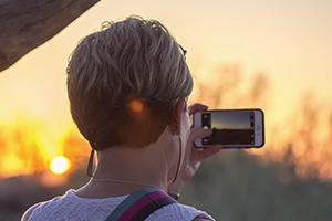 Guest taking sunset photo with cellphone